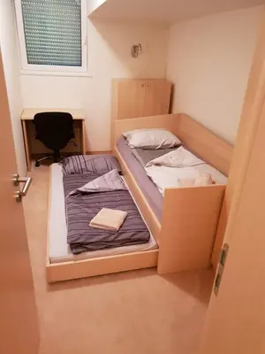 two bunk beds in a small room with a door at Luxury apartment with a nice view in Kranjska Gora in Kranjska Gora