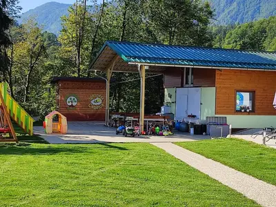 a playground with a building at Apartments and Wellness Jelovca in Radovljica