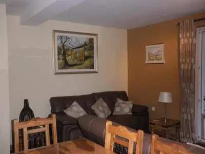 a living room with a couch and a table at Soča House in Kobarid