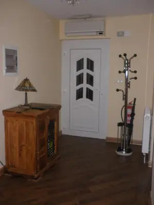 a room with a door and a table with a lamp at Soča House in Kobarid