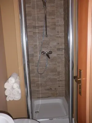 a shower in a bathroom with a bath tub at Soča House in Kobarid