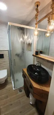 a bathroom with a black sink and a shower at Apartment Central Station between Dragon and Triple Bridges in Ljubljana