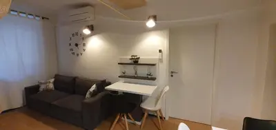 a living room with a couch and a table at Apartment Central Station between Dragon and Triple Bridges in Ljubljana
