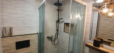 a bathroom with a shower with a glass door at Apartment Central Station between Dragon and Triple Bridges in Ljubljana