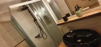 a bathroom with a black sink and a glass door at Apartment Central Station between Dragon and Triple Bridges in Ljubljana