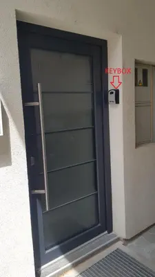 a glass door with a sign on the side of a building at Apartment Central Station between Dragon and Triple Bridges in Ljubljana