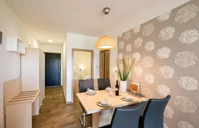 a dining room with a table and chairs at Apartmaji BANONIA 