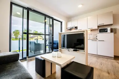 a living room with a couch and a table at Apartmaji BANONIA 
