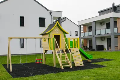 a playground in a yard with a slide at Apartmaji BANONIA 