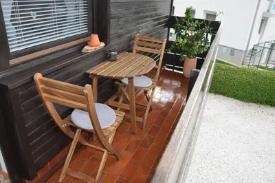 a small patio with two chairs and a table at Studio Tara with balcony in Bled