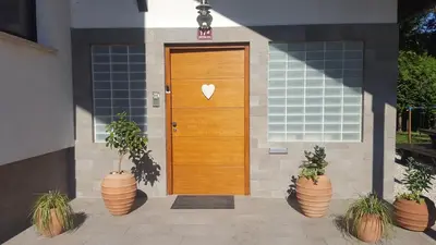 a wooden door with a heart on it on a house at Studio Tara with balcony in Bled