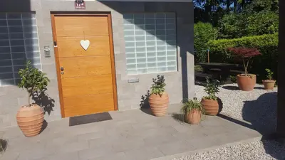 a wooden door with a heart on it next to potted plants at Studio Tara with balcony in Bled
