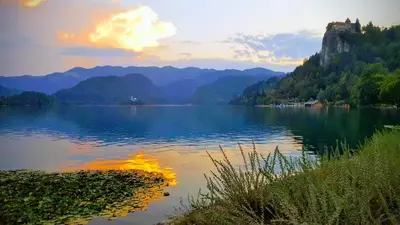 a view of a lake with a castle on a mountain at Studio Tara with balcony in Bled