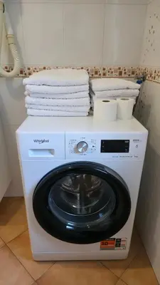 a washing machine with towels on top of it at Vila Bbq in Ljubljana