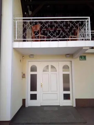 a balcony above a white door and a building at Vila Bbq in Ljubljana