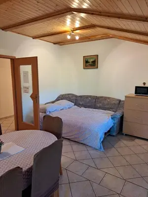 a living room with two beds and a couch at Penzion Na Hribu in Slap