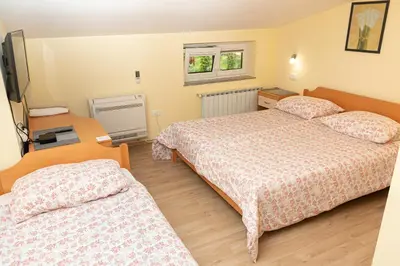 a hotel room with two beds and a television at Penzion Na Hribu in Slap