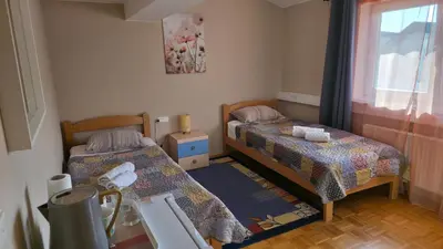 a small room with two beds and a window at Vila Bbq in Ljubljana