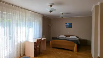 a bedroom with a bed and a large window at Vila Bbq in Ljubljana
