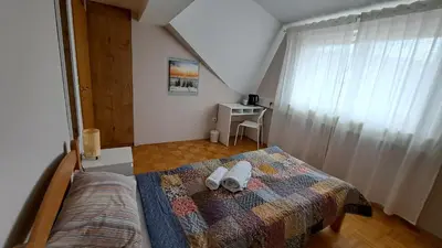a bedroom with a bed with two towels on it at Vila Bbq in Ljubljana