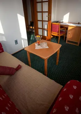 a small table in a room with a table and a chair at Guesthouse Tulipan in Lesce