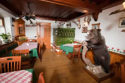 a statue of a bear standing in a restaurant at Guesthouse Tulipan in Lesce