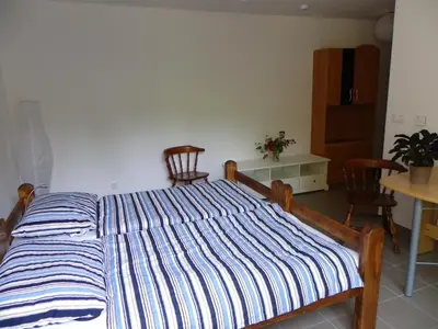 a bed with a blue and white striped comforter in a room at The Millhouse Bled in Bled