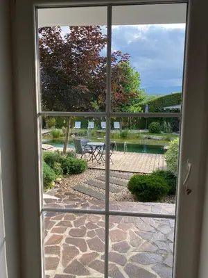 a view of a patio through a sliding glass door at Garden Paradise Bled Apartments - garden, pond and castle view in Bled