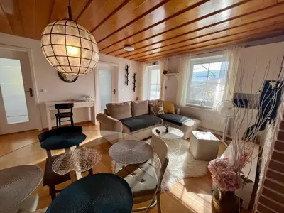 a living room with a couch and a table at Garden Paradise Bled Apartments - garden, pond and castle view in Bled