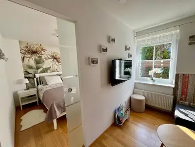 a small room with a bed and a window at Garden Paradise Bled Apartments - garden, pond and castle view in Bled