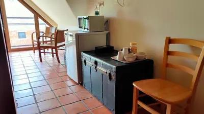 a kitchen with an old refrigerator and a table and chairs at Bed & Breakfast Na Poljani in Kranj