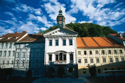 a building with a clock tower on top of it at Apartment Optim in Ljubljana