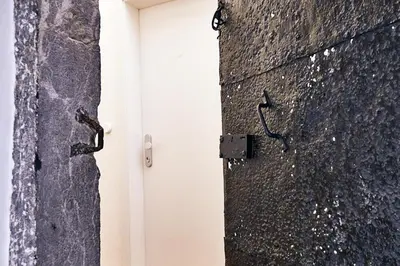 a door in a wall next to a building at Central Riverside Apartments Meščanka in Ljubljana