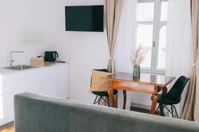 a living room with a table and a couch at Central Riverside Apartments Meščanka in Ljubljana