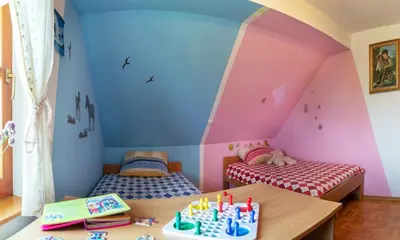 a room with two beds with a birthday cake on a table at PLANINCA -hiša z razgledom in Šmarje pri Jelšah