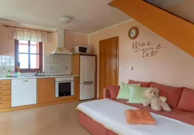 a living room with a couch with a teddy bear on it at PLANINCA -hiša z razgledom in Šmarje pri Jelšah