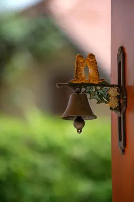 a door bell with a pair of shoes on it at PLANINCA -hiša z razgledom in Šmarje pri Jelšah