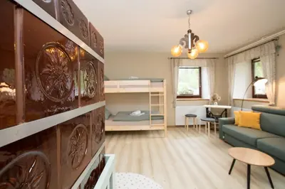 a small living room with a couch and a bedroom at Apartma Pr Gatej in Bohinj