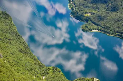 an object is flying in the sky over a lake at Apartma Pr Gatej in Bohinj