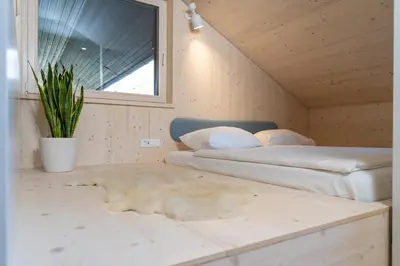 a bedroom with two beds and a potted plant at TD Bohinj Apartments in Bohinj