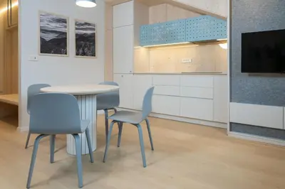a room with a table and chairs and a tv at TD Bohinj Apartments in Bohinj