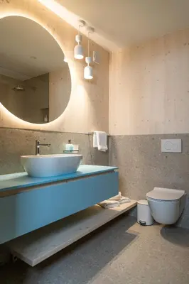 a bathroom with a sink and a toilet and a mirror at TD Bohinj Apartments in Bohinj