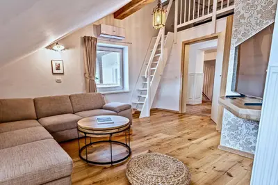 a living room with a couch and a table at Apartments Koledniki in Bled