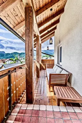 a balcony with benches and a view of the ocean at Apartments Koledniki in Bled