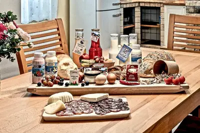 a table with different types of bread and food on it at Apartments Koledniki in Bled