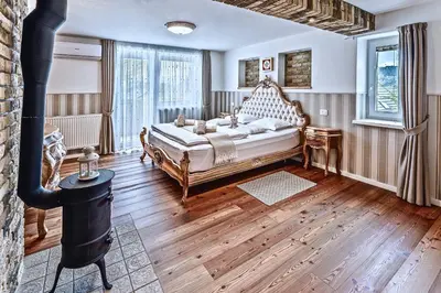 a bedroom with a bed and a wood stove at Apartments Koledniki in Bled