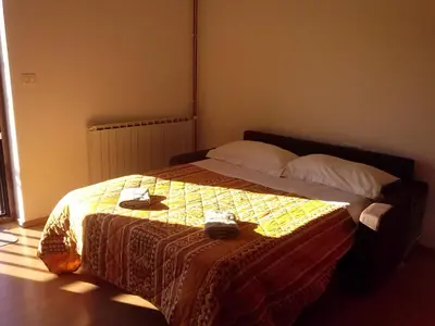 a bedroom with a bed with a quilt on it at Krasen Kras Apartment in Komen