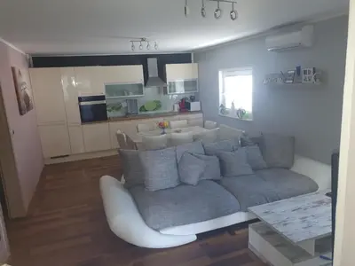 a living room with a couch and a kitchen at Sanja apartment near to Ljubljana in Preserje pri Radomljah