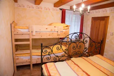 a bedroom with two bunk beds in a room at Apartment Pod Skalco in Jesenice