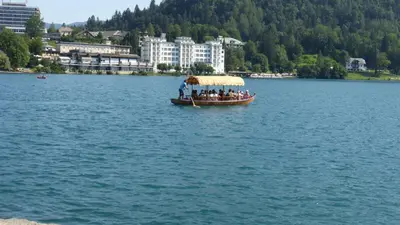 a group of people on a boat on a lake at Apartment Pod Skalco in Jesenice